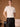 Closer front view of the Soft Ivory cashmere sweater, showing its softly brushed texture and ribbed neckline, cuffs and hem.