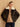 Front view of the Espresso Brown cashmere bomber jacket with ivory shearling collar, worn open over a camel sweater and dark denim.