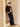 Full-length three-quarter side view of the Espresso Brown cashmere bomber jacket with ivory shearling collar, paired with dark denim and pointed boots.