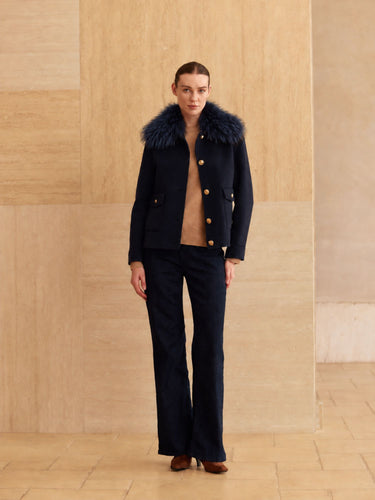 Full-length front view of the Midnight Navy cashmere bomber jacket with fur collar, worn over a camel sweater and dark denim.