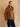 Three-quarter front view of the Warm Camel cashmere bomber jacket, showing the fur collar, front patch pocket and banded hem.