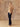 Full-length front view of the Almond cashmere sweater and matching fringed scarf, styled with dark wide-leg denim and brown boots.