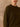 Close-up of the Olive cashmere sweater, showing the crew neckline and ribbed detailing at the shoulder.