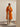 Full-length view of the Burnt Pumpkin cashmere wrap coat, worn open over an ivory top and wide-leg trousers.
