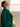 Close side view of the Emerald Green cashmere wrap coat, showing the notched collar, shoulder and soft drape over an ivory top.