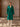 Full-length front view of the Emerald Green Classic Cashmere Wrap Coat, belted over ivory wide-leg trousers.
