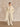 Model wearing the Classic Cashmere Wrap Coat in Ivory open with hands in the side pockets, paired with tonal wide-leg trousers.