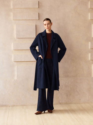 Full-length front view of the Midnight Navy Classic Cashmere Wrap Coat, worn open over a burgundy sweater and dark wide-leg denim.