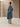 Three-quarter back view of the Classic Cashmere Wrap Coat in Powder Blue, showing the belted waist and straight silhouette.
