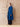Full-length side view of the Royal Blue cashmere wrap coat, worn open over dark denim and brown pointed boots.