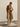 Model wearing the Classic Cashmere Wrap Coat in Warm Camel open over ivory knitwear and wide-leg trousers, full-length front view.