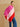 Model wearing the Rose Multi colorblock cashmere topper with an asymmetric pointed drape and tonal buttons along the shoulder.