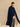 Closer front view of the cashmere travel wrap, showing the Midnight Navy and flecked Beige Donegal colorblock panels.