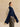 Side view of the Navy and Beige Donegal cashmere travel wrap, showing long navy panels and flecked beige sections draped over the shoulders.