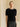 Front view of the Midnight Noir brushed cashmere short-sleeve sweater with a jeweled crew neckline, worn with a black satin skirt.