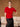 Front view of the Ruby Red brushed cashmere short-sleeve sweater with a jeweled crew neckline, worn with a black satin skirt.