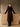 Full-length front view of the Chocolate Brown long cashmere coat with fur collar, gold-tone buttons and a shaped waist, worn over black trousers.