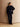Full-length view of the Reversible Cashmere Car Coat worn on the Navy side over a navy sweater and dark denim with brown boots.