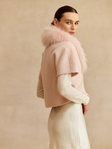 Close-up of the Blush cashmere jacket, showing the matching fur collar, short sleeve and rounded front edge.