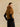 Three-quarter back view of the Camel short-sleeve cashmere jacket, showing the fur collar and high-hip cut.