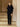 Full-length front view of the Midnight Navy short-sleeve cashmere jacket with fur collar, worn over a black top and trousers.