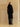 Full-length back view of the Jet Black Signature Cashmere Wrap Coat with fur collar, worn over black leather trousers.