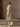 Full-length three-quarter back view of the Soft Ecru Signature Cashmere Wrap Coat with fur collar, paired with tonal wide-leg trousers.