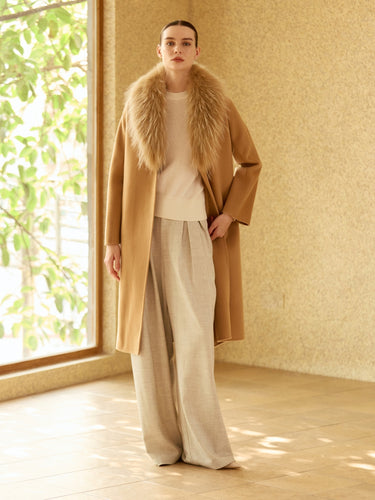 Full-length front view of the Warm Camel Signature Cashmere Wrap Coat with fur collar, worn open over ivory knitwear and wide-leg trousers.