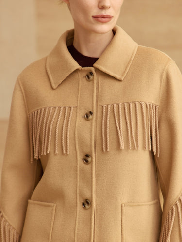 Close-up of the Warm Sand Western Fringe Cashmere Jacket, showing the point collar, twisted chest fringe, buttons and patch pockets.