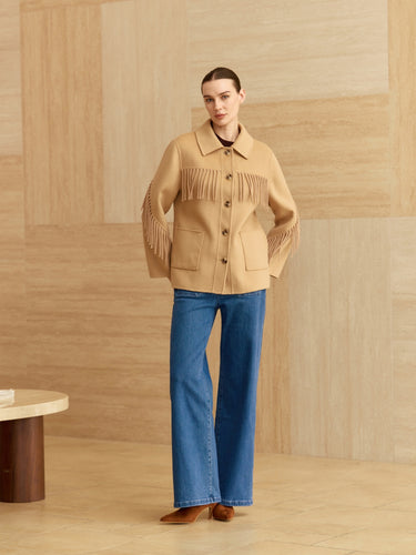 Full-length front view of the Western Fringe Cashmere Jacket in Warm Sand, styled with blue wide-leg denim and brown boots.