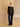 Full-length front view of the Espresso Brown cashmere bomber jacket with ivory shearling collar, styled with dark wide-leg denim and pointed boots.