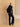 Full-length three-quarter side view of the Midnight Navy cashmere bomber jacket with fur collar, styled with dark denim and pointed boots.