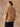 Closer back view of the Almond cashmere sweater, with the matching scarf draped into a fringed point across the back.