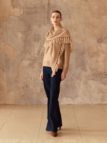 Full-length front view of the Almond cashmere sweater and matching fringed scarf, styled with dark wide-leg denim and brown boots.