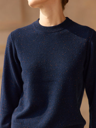 Close front view of the Midnight Navy Donegal cashmere sweater, showing the crew neckline, color flecks and ribbed shoulder detailing.