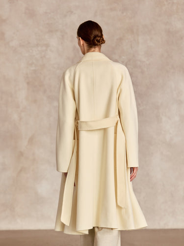Back view of the Classic Cashmere Wrap Coat in Ivory, showing the wide sleeves and belt resting across the waist.