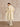 Three-quarter back view of the Classic Cashmere Wrap Coat in Ivory, showing the generous sleeves, side pocket and draped belt.