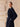 Three-quarter side view of the Midnight Navy cashmere wrap coat, showing the belted waist, generous sleeve and side pocket.