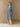 Full-length front view of the Classic Cashmere Wrap Coat in Powder Blue, belted over ivory wide-leg trousers.