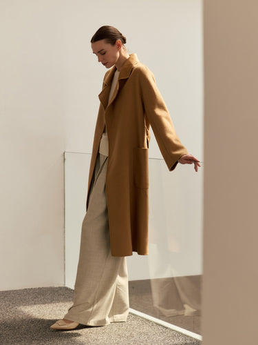 Side view of the Classic Cashmere Wrap Coat in Warm Camel, worn open to show the generous sleeves and straight silhouette.