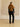 Full-length back view of the Camel cashmere jacket with fur collar, styled with black trousers and heeled sandals.