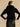 Closer back view of the Jet Black cashmere jacket, showing the fur collar across the shoulders, short sleeves and compact silhouette.
