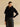 Closer front view of the Jet Black cashmere jacket, showing the fur collar, short sleeves and rounded front edges.