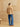 Full-length back view of the Western Fringe Cashmere Jacket in Warm Sand, paired with blue wide-leg denim and brown boots.